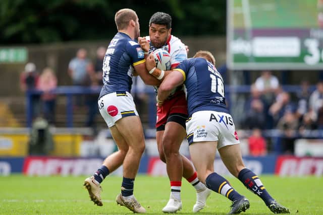Rhinos' Jarrod O'Connor, left and Tom Holroyd get to grips with Leigh's John Asiata. Picture by Ian Hodgson/PA Wire.