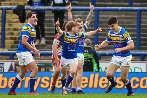 Rhinos unsder-18s celebrate after Jack Sinfield, right, kicked the winning point in a Headingley victory over Wigan this season. Picture by Alex Whitehead/SWpix.com.