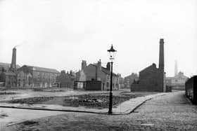 Camp Fields area after housing clearance, showing public houses and remaining mills. The Grove Inn can be seen at the bottom of Back Row, Bricklayers Arms in the middle of Middle Row. Hope Mills, which at this time housed Denby and Spinks, upholstery works, is on the far left, on Front Row. Pictured in September 1938.