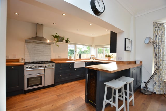 The kitchen is fitted with contemporary shaker style units, with a breakfast bar divider. It also has high specification appliances and space for a rangemaster cooker, with an integrated extractor fan above.
