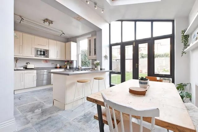 The dining area has two Velux roof lights and French doors with side glazed panels opening into the garden allowing for plenty of natural light.