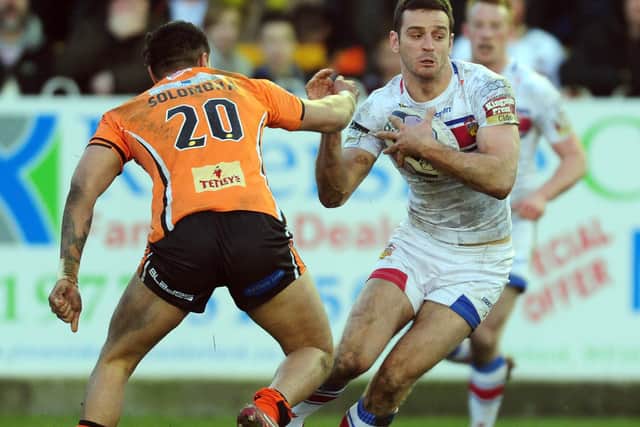 Craig Hall evades Denny Solomona during Trinity's last win over Tigers, in February, 2015. Picture James Hardisty.