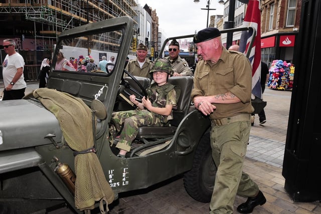 Sam Coulter, nine, of Bingley in a jeep restored by Paul McEvoy (right) of Morley.