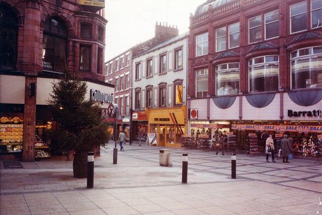 Commercial Street, right, at the junction with Lands Lane, left. The area was pedestrianised in the 1970s. On the corner, left, is Collingwood Jewellers at numbers 8 and 9 Commercial Street. Barratts shoe shop is at the right edge, with a sale in progress, at numbers 36 to 38 Commercial Street. Shoes on the display outside are priced at 8,9,10 and 12 pounds. Next door is Foto Processing at number 39 followed by DER Television Rental and Beaverbrooks at numbers 40 and 41 respectively. Pictured in September 1982.