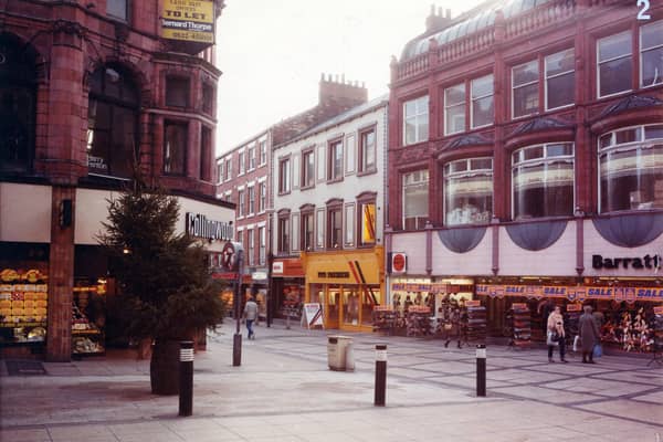 Commercial Street, right, at the junction with Lands Lane, left. The area was pedestrianised in the 1970s. On the corner, left, is Collingwood Jewellers at numbers 8 and 9 Commercial Street. Barratts shoe shop is at the right edge, with a sale in progress, at numbers 36 to 38 Commercial Street. Shoes on the display outside are priced at 8,9,10 and 12 pounds. Next door is Foto Processing at number 39 followed by DER Television Rental and Beaverbrooks at numbers 40 and 41 respectively. Pictured in September 1982.