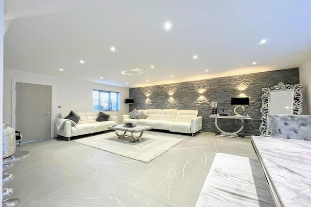 "A spacious lounge offering LED spot lighting to the ceiling, porcelain tiled flooring with underfloor heating, a front facing PVCu double glazed window and double glazed bi folding doors accessing the rear garden," says the brochure.
