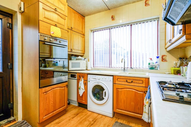 The kitchen is fitted with great appliances and floor and ceiling storage.
