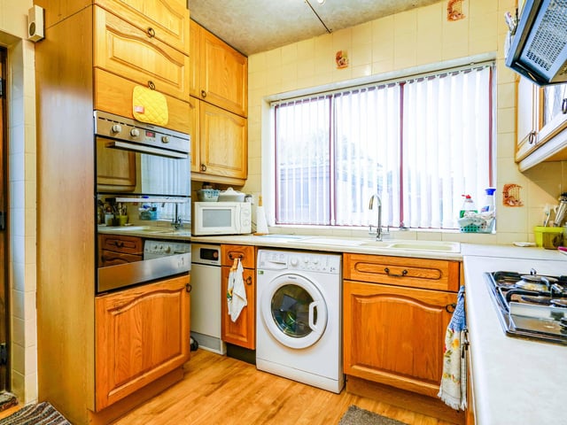 The kitchen is fitted with great appliances and floor and ceiling storage.