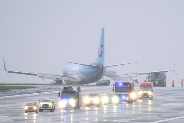 Emergency services at the scene after a passenger plane came off the runway at Leeds Bradford Airport while landing in windy conditions during Storm Babet