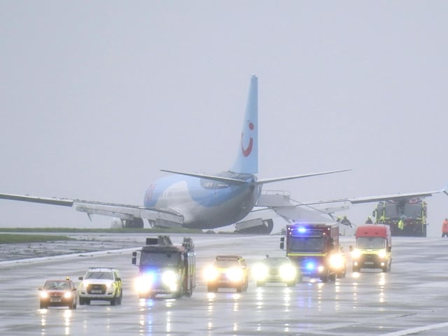 Emergency services at the scene after a passenger plane came off the runway at Leeds Bradford Airport while landing in windy conditions during Storm Babet