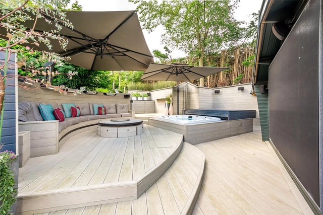 At the rear of this beautiful home sits an open-air spa with a jacuzzi and horseshoe seating around an outdoor cinema.