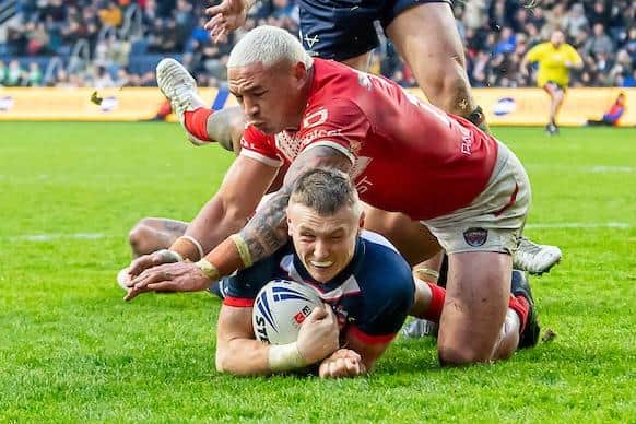 Leeds Rhinos' Harry Newman gets past Tyson Frizell to score his first England try in their 26-4 win against Tonga at Headingley. Picture by Allan McKenzie/SWpix.com.