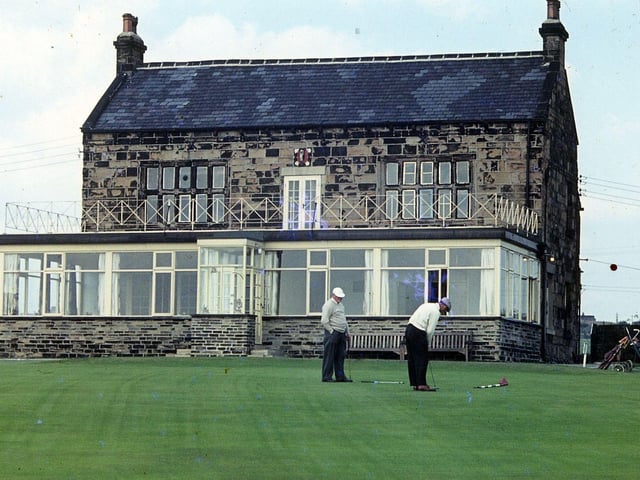Two golfers are putting at the 18th green at at Howley Hall Golf Course in September 1962. The clubhouse was originally the Bailiff's House to Howley Hall, the former mansion whose ruins can still be seen in the grounds. It was leased by the golf club as their clubhouse in 1905, after they already had 63 acres of land around it. .