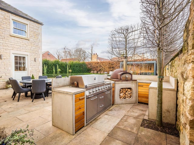 Wind down on summer nights with this outdoor cooking and dining area.