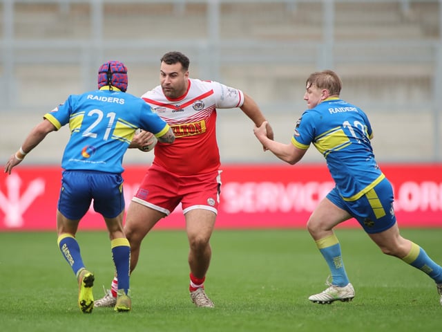 Jake Walker, of East Leeds, tries to find a way past Oulton Raiders' Nathan Waring and Ben Brady in the National League One play-off final.