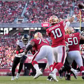 SANTA CLARA, CALIFORNIA - DECEMBER 19: Jimmy Garoppolo #10 of the San Francisco 49ers delivers a pass over the defense of the Atlanta Falcons in the fourth quarter of the game at Levi's Stadium on December 19, 2021 in Santa Clara, California. (Photo by Thearon W. Henderson/Getty Images)