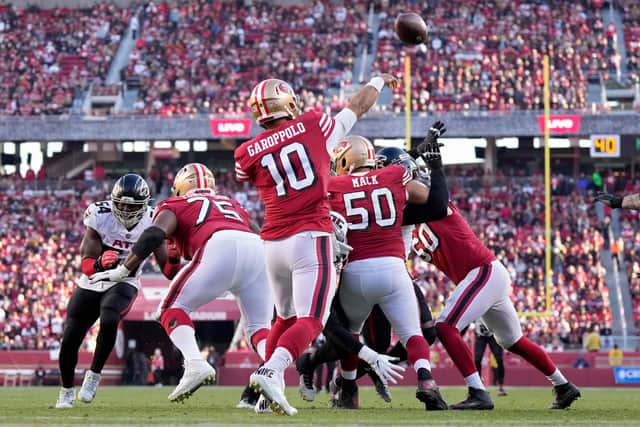 SANTA CLARA, CALIFORNIA - DECEMBER 19: Jimmy Garoppolo #10 of the San Francisco 49ers delivers a pass over the defense of the Atlanta Falcons in the fourth quarter of the game at Levi's Stadium on December 19, 2021 in Santa Clara, California. (Photo by Thearon W. Henderson/Getty Images)
