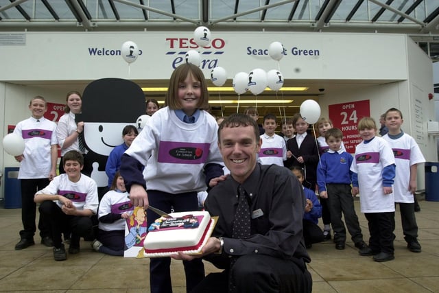 Leane Farrell, 11, a pupil at Our Lady of The Counsel School, Leeds, cutting the celebratory cake with Robin Chambers, customer service manager for Seacroft Tesco, to celebrate the launch of Tesco Computers for Schools 2001 at the store at Seacroft Green, on January 31. 2001.
