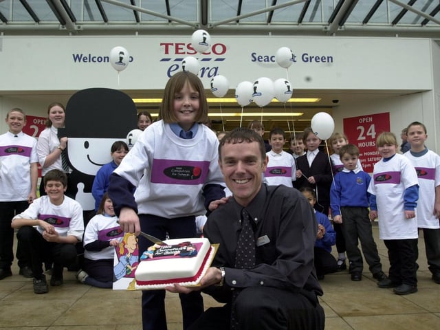 Leane Farrell, 11, a pupil at Our Lady of The Counsel School, Leeds, cutting the celebratory cake with Robin Chambers, customer service manager for Seacroft Tesco, to celebrate the launch of Tesco Computers for Schools 2001 at the store at Seacroft Green, on January 31. 2001.