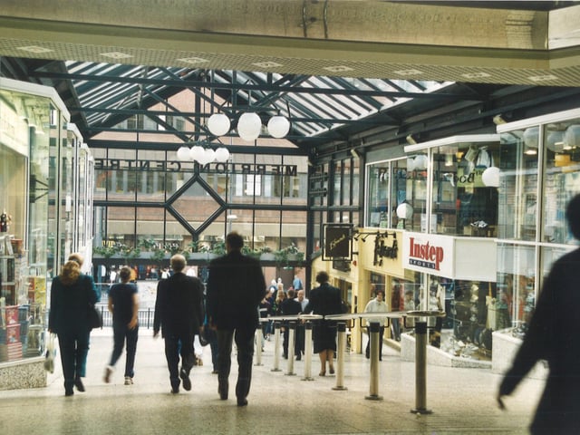 Shops featured are on the right Instep Sports shop and Edwards wine bar. A book shop can be seen on the left.