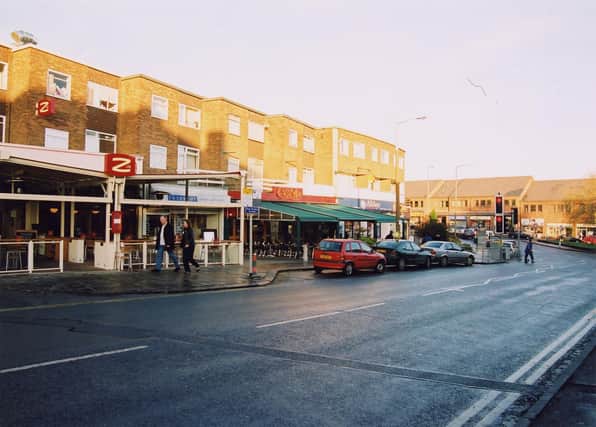 Stainbeck Lane and the junction with Harrogate Road in 2003. On the left is Zed's cafe bar, moving right, Interior Inspirations then number 10 Casa Mia, an Italian coffee shop. Alldays convenience store is the last shop on the right in view on Stainbeck Lane. From the centre to the left Harrogate Road can be seen.