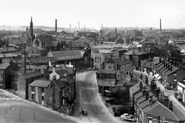 Crab Lane runs up the centre to the junction with Stocks Hill, with the parapet of the Midland Bank, Armley Branch Library, the Yorkshire Penny Bank and Malt Shovel public house seen in the middle. To the right is Branch Road with the edge of the Western Cinema on the far right and the Post Office further along. In the background are the Wesley Road Methodist Chapel, the roof of Armley Baths and the line of Town Street.