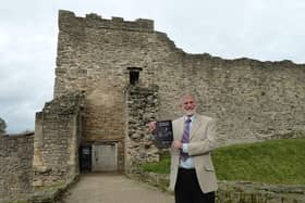 HIstorian and former teacher John Smith outside Pickering Castle which inspired his medieval stories