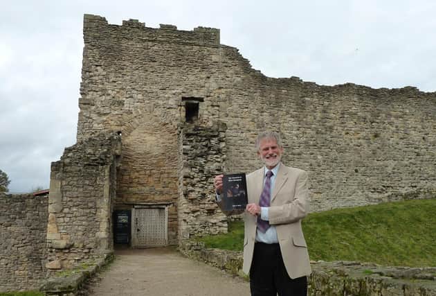 HIstorian and former teacher John Smith outside Pickering Castle which inspired his medieval stories