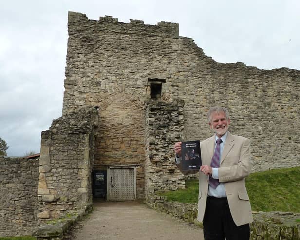 HIstorian and former teacher John Smith outside Pickering Castle which inspired his medieval stories