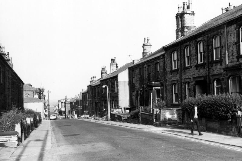 Albion Street looking north-east towards Queen Street in July 1971. Morley Town Hall is just out of view to the left. A school boy is walking past the terraced houses on the right hand side.