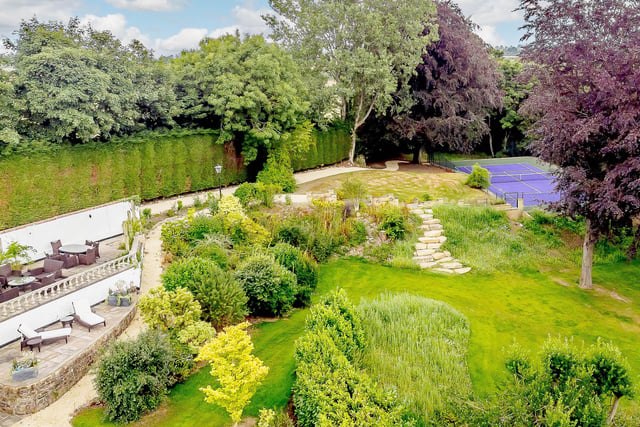 Cleverly designed gardens include meadow areas, woodland, an orchard, a tennis court.....and Crimple Beck.