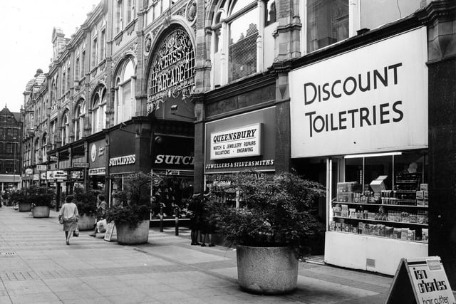 Queen Victoria Street looking towards Vicar Lane from the direction of Briggate. On the right is Discount Toiletries then Queensbury Jewellers. Next is the entrance to the Cross Arcade then Sucliffes Sport and Leisure. Pictured in June 1984.
