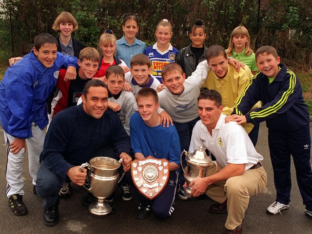Leeds Rhinos stars Martin Masella and Damian Gibson were guests of honour at Wortley High in September 1997 where they presented the awards at the school's annual sports presentation evening. They are pictured presenting awards to the school's U-13s football team who won the Leeds West Area League, the Leeds School's Under 13 Cup, the Airedale and Wharfedale District Cup and runners-up in the West Yorkshire Cup Competition. Receiving the awards on behalf of the team is their goal keeper James Senior, 13, recently signed on a 2 year agreement with Ipswich Town. Behind him some of the team members from the left, Wesley King, Matthew Goodwin, Andrew Bell, Matthew Richardson, Tom O'Brien, Sam Sykes and Stuart Kirk watched by some of the team's ardent supporters.