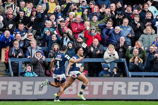 Nene Macdonald (number four) celebrates after Derrell Olpherts' try against Catalans. Picture by Alex Whitehead/SWpix.com.
