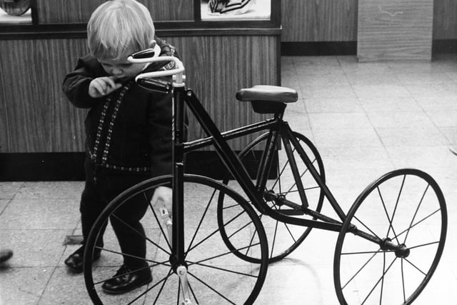 Dare he ride it? Leeds City Museum staged a Christmas Exhibition of 'Yesterday's Toys' in November 1970. Young Timothy Adamson makes a cautious assessment of a vintage tricycle