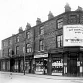 A view of old shop premises in Hunslet Lane at the junction with South Row. In view is a greengrocers, proprietor, Harry Sidebottom, a tobacconists shop and Jim's Cozy Cafe. A sign above the window advertising the News of the World newspaper states 'Mr Anthony Armstrong-Jones, the unknown celebrity' South Market Cafe is on the corner at number 58. The row was demolished in accordance with he 1957 Housing Act.