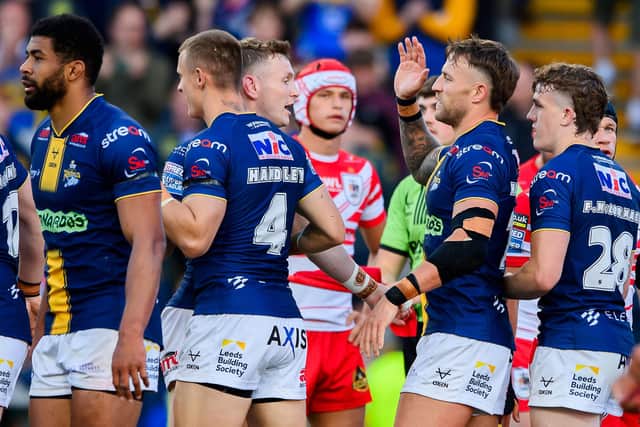 Chris Hankinson, second from right, celebrates after scoring during Leeds Rhinos' 24-16 win against St Helens in June. Coach Brad Arthur expects this week's rematch to be just as tough. Picture by Allan McKenzie/SWpix.com.