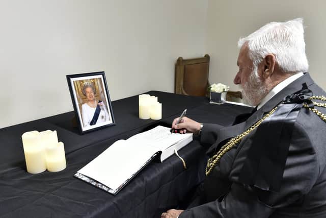 The Lord Mayor of Leeds, Coun Robert Gettings, signs the book of condolence at Civic Hall. Picture: Steve Riding