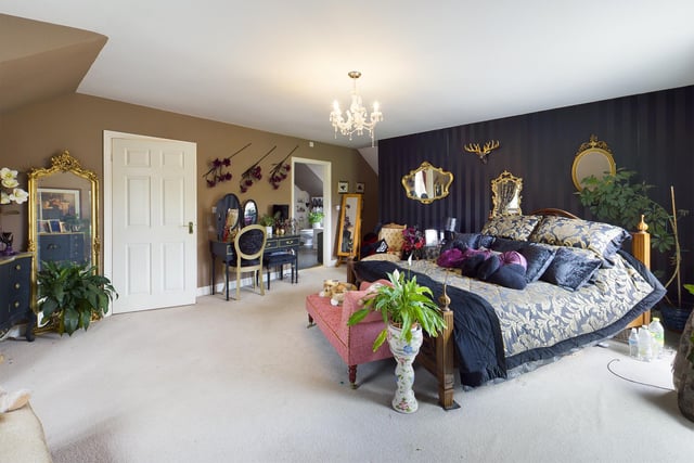 The sizeable bed is centre stage in this large and lovely double bedroom.