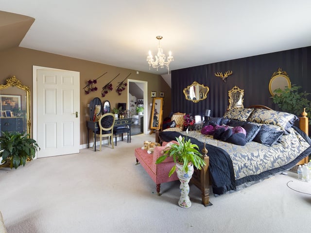 The sizeable bed is centre stage in this large and lovely double bedroom.