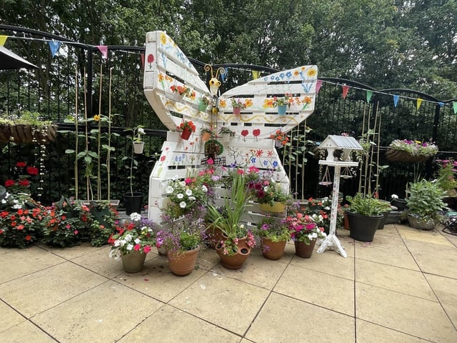 Patio with butterfly sculpture at HC-One’s Snapethorpe Hall Care Home