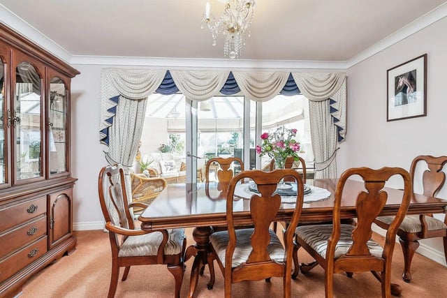 The separate dining room is a great entertainment space with sliding glass doors leading to the conservatory.