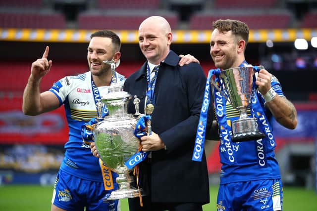Richard Agar, flanked by  captain Luke Gale, left and man of the match Richie Myler, with the Challenge Cup at Wembley in 2020. Picture by Michael Steele/Getty Images.