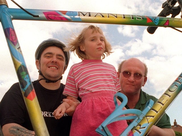 Young autism sufferer Claire Copley from Allerton Bywater pictured in May 1997. Her dad's friend, Kevin Weaver, was preparing to do  a solo triathlon to raise money to send Claire away for specialised treatment. Pictured is Claire and dad Tommy with Kevin and his bike.