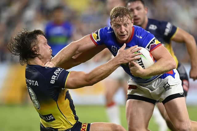 Rhinos signing Lachie Miller is tackled by Reuben Cotter of  North Queensland Cowboys during Newcastle Knights' away NRL fixture at Qld Country Bank Stadium, in Townsville, Australia, on April 22, 2023. Picture by Ian Hitchcock/Getty Images.