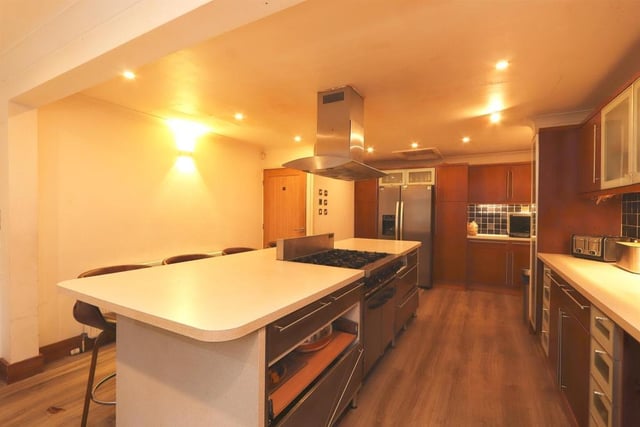 The dining kitchen has a range of high and low level cupboards, drawers, centre island breakfast bar with hob, integral oven, sink unit with mixer taps, tiled splash backs, coving, double radiator, window to the front and side access door.