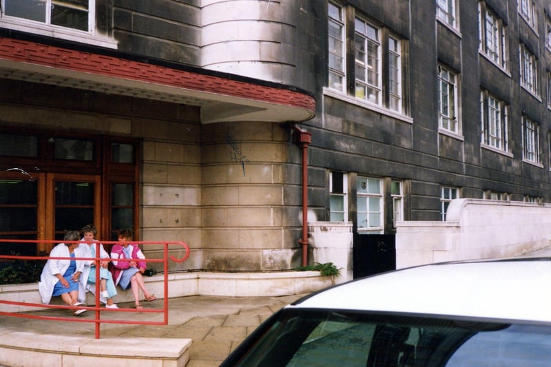 Three members of the nursing staff sit outside the Calverley Street entrance to Leeds General Infirmary in November 1990.
