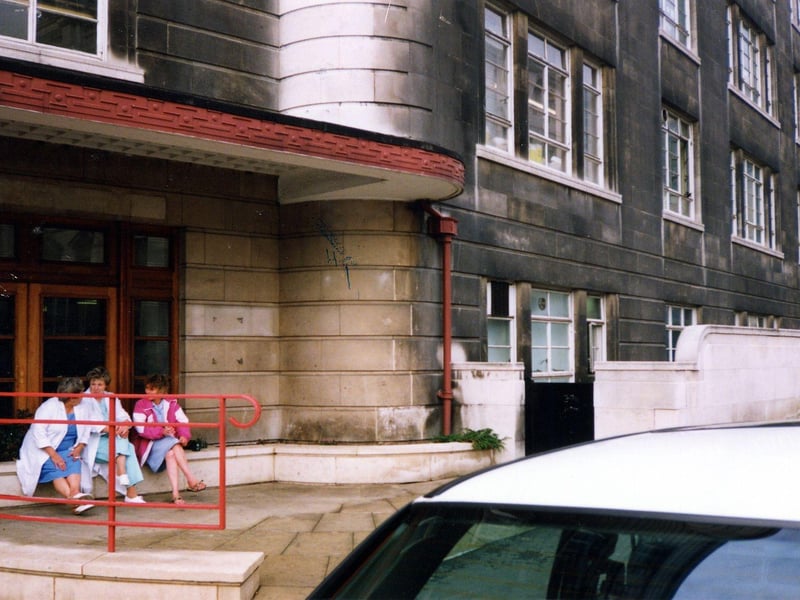 Three members of the nursing staff sit outside the Calverley Street entrance to Leeds General Infirmary in November 1990.