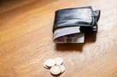 A wallet with some notes and coins