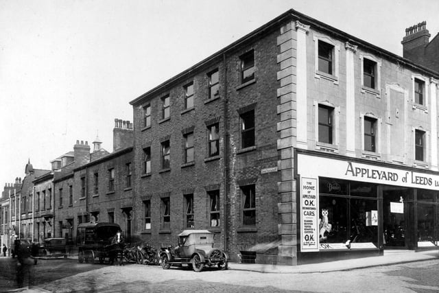 The corner of Upper Fountaine Street and North Street in August 1927.. Along Upper Fountaine Street comes a horse and cart for the 'Express Parcel Service' to the right are parked two motorcycles and a car. On the corner of North Street is a large car showroom belonging to Appleyard of Leeds. The store looks fairly new and has a large sign over a new shopfront saying 'Appleyard of Leeds Ltd.'